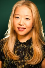 Photo of author Grace Jung. The photo is taken from a slight angle and Grace looks at the camera with a small smile.